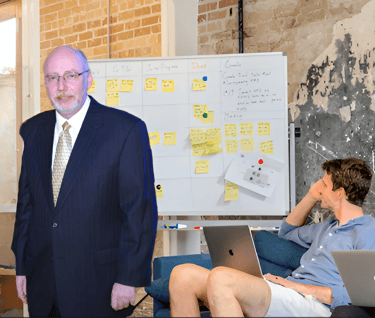 Scott Randy Gerber standing in front of a white board with a group