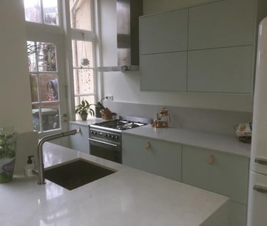 a kitchen with a sink, stove, and refrigerator