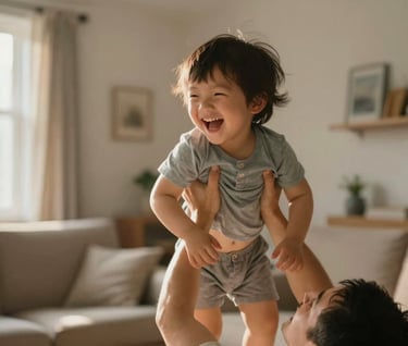A candid moment of a child laughing while being lifted in the air by a parent. The background is a cozy, warm-toned living room with sunbeams. The style is cinematic and spontaneous, reflecting deep family bonds.