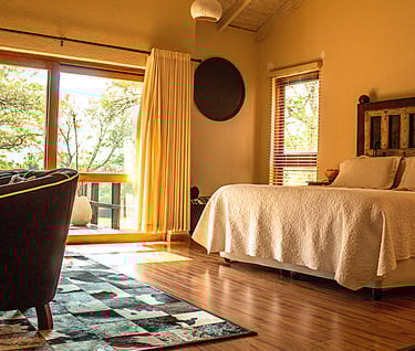 a bedroom with a bed and a chair