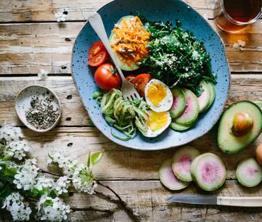 a bowl of food with a fork and knife on a table
