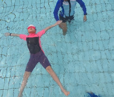 child learning backfloat at bishan swimming complex