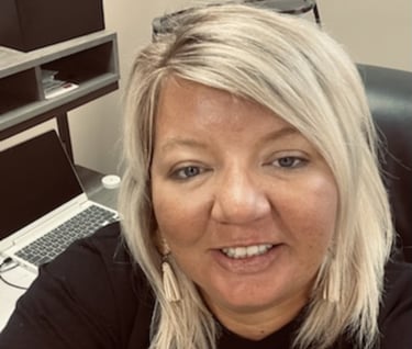 a woman in a black shirt and a laptop