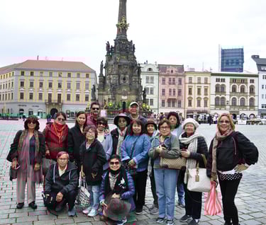 a group of people standing in front of a clock tower