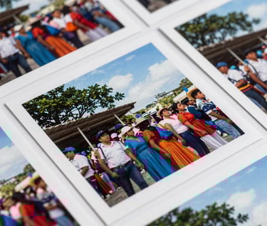 Detailed view of high-resolution photographic prints of a South American / Colombian social event, vibrant but natural colors, soft white and sky blue tones.