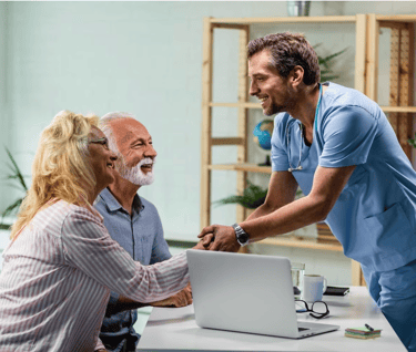 happy senior couple with their doctor