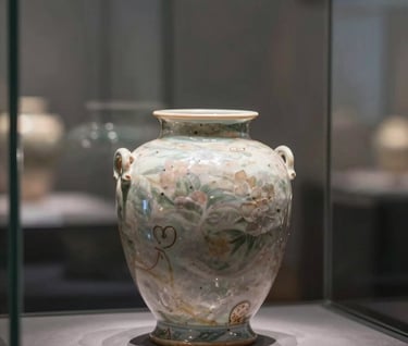 An exquisite antique object, possibly a rare ceramic or stone vessel, displayed in a glass case. Reflections of a sophisticated interior in #5F5B54 are visible on the glass. Subtle, premium lighting.