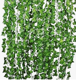 a green ivy planter hanging from a wall