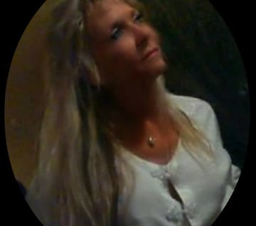 a woman with long blonde hair and a white shirt
