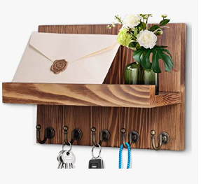 a wooden shelf with a vase and a vase with flowers