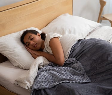 a woman is sleeping in a bed with big pillow 