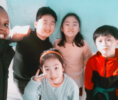 Emmy standing with 4 learners