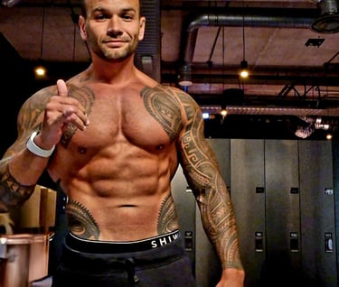 a man with tattoos on his chest and chest