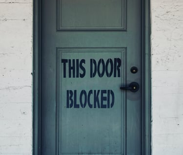 Door with the words "This Door Blocked"