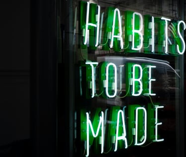neon sign reads "Habits to be Made"