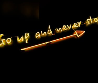 sign with arrow pointing up reading "Go up and never stop."