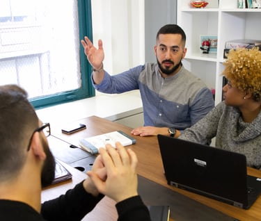 group of young people working/discussing in office 