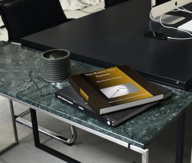 a table with a cup of coffee and a book "The Master Key System"