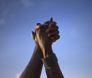 two hands holding hands with a sky background