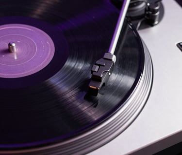 Close-up of a premium turntable and vinyl record spinning, minimalist aesthetic with obsidian black and electric violet light trails, Spanish / Latin American lounge setting.