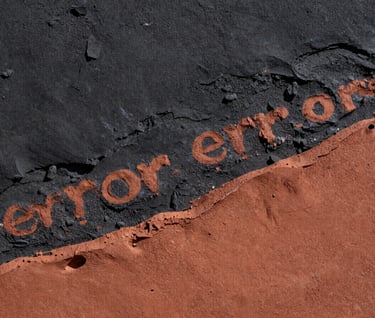 A high-contrast macro photograph focusing on the textured surface of an artwork. Visible layers of deep charcoal and soft terracotta pigments create a rugged, tactile landscape. The lighting is harsh and dramatic, emphasizing the 'error' and transformation in the South American / Argentine artistic process.