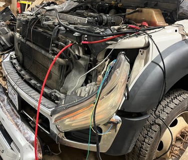 truck with its hood open and wires hanging out of it