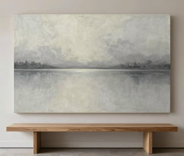A large-scale atmospheric painting in soft greys and off-whites, styled above a minimalist oak console table in a contemporary North American entryway.