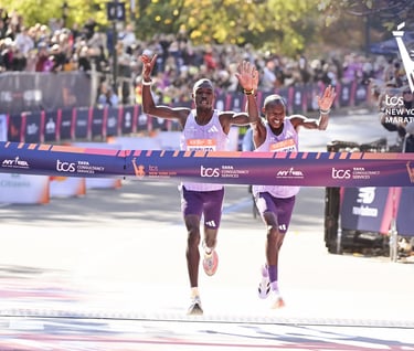 Benson Kipruto (left) and Alexander Mutiso (right) in a photo finish sprint at the 2025 NYC Marathon finish line, showing the