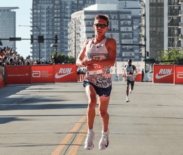 Conner Mantz of the USA at finish line of the 2025 Chicago Marathon, celebrating after breaking the 23-year record