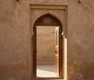 An artistic shot of a traditional Middle Eastern / Gulf doorway with soft golden sunlight streaming through, casting warm shadows. The environment is warm and cinematic, featuring a palette of soft tan and burnt terracotta.
