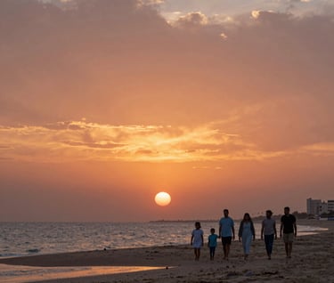 A wide cinematic shot of a family walking along a beach at sunset in a Middle Eastern / Gulf coastal city. The sky is filled with burnt terracotta and soft gold. Authentic and peaceful lifestyle storytelling style.