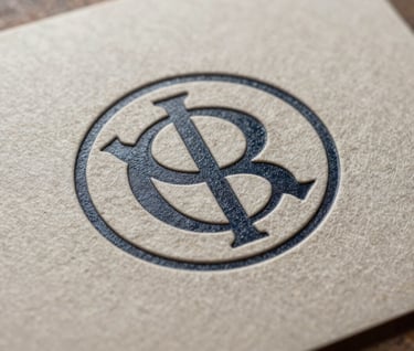 A macro photograph showing the intricate detail of an embossed logo on a heavy-weight paper package, highlighting meticulous craftsmanship and texture under professional studio lighting.