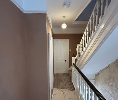 Renovation of the hallway of a house with plastered walls.