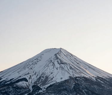 Minimalist photography of a single snow-capped peak under a vast ivory sky, centered composition, soft shadows, North American winter setting.