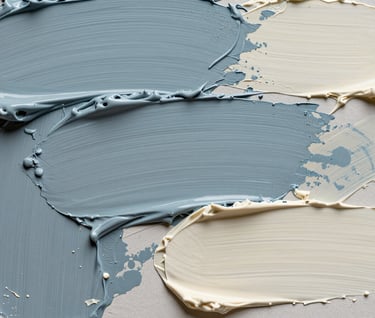A macro photograph of artistic textures, showing palette knife strokes in muted slate blue and soft ivory. Soft, professional studio lighting in a European / French artist's atelier.