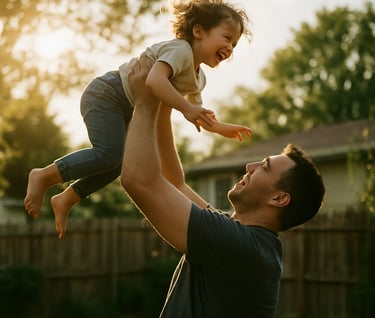 A father playfully lifting his child toward the sky in a North American backyard. The image is candid and full of movement, shot in a cinematic style with warm, sun-drenched highlights.