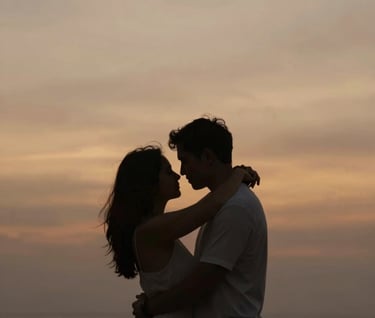 A silhouette of a couple embracing against a vibrant but soft Bali sunset, warm amber and taupe tones #C7B7A3, elegant and minimalist composition.
