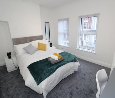 bedroom with bed and white walls