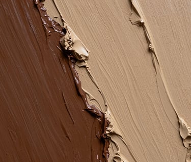 Detailed close-up of a painting where deep brown acrylic paint meets sandy beige molding paste. The texture is rough and organic, resembling weathered stone or natural clay.