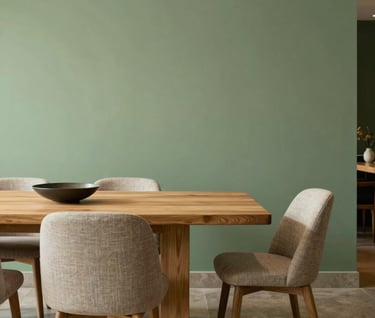 Sophisticated dining area with a sage green accent wall, light oak dining table, and contemporary South American furniture, illuminated by soft warm ambient lighting.