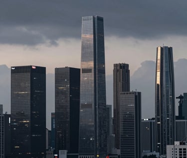 Wide cinematic shot of a futuristic urban skyline at dusk. The sky is a moody Charcoal Slate with hints of Steel Mist, featuring architecture that looks sleek and high-end, captured with sharp professional focus.