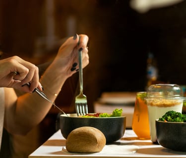a woman is holding a fork and fork in her hand
