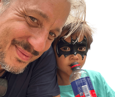 a man in a mask mask and a child in a mask mask