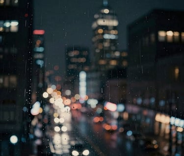 A cinematic shot of blurred city lights through a rainy window at night in a North American city. Deep black and charcoal tones with streaks of off-white light. Evocative, modern, and moody atmosphere.