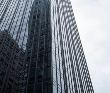An abstract perspective of a skyscraper's glass corner against a bright white sky. The reflections are sharp and dark gray, embodying a bold, futuristic look for a South American / Brazilian commercial development.