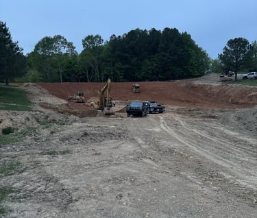digging a big pond, large excavator and dozer digging a pond