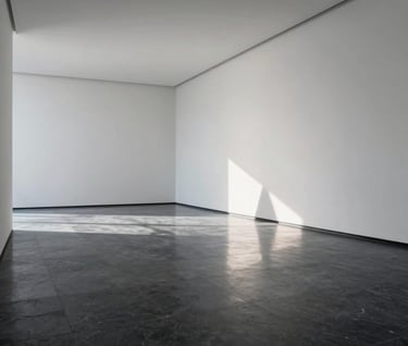 A wide interior shot of a minimalist gallery space. The floors are polished dark slate, reflecting the pale ice white walls. The room is empty except for one geometric sculpture that casts a long, thin shadow.