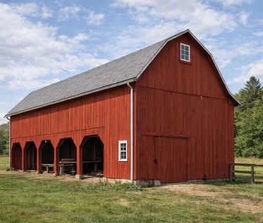 an old farmhouse restored in the traditional red barn color