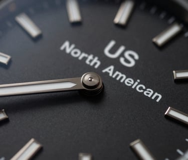 Macro photography of a high-end designer watch face with a matte black finish, clean typography on the dial, North American / US luxury lifestyle aesthetic, dramatic chiaroscuro lighting.