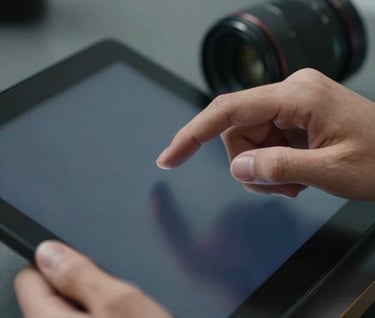 A close-up photograph of a professional using a sleek touch-screen interface, focusing on the refined hand movement, soft lighting with shades of midnight blue and grey.